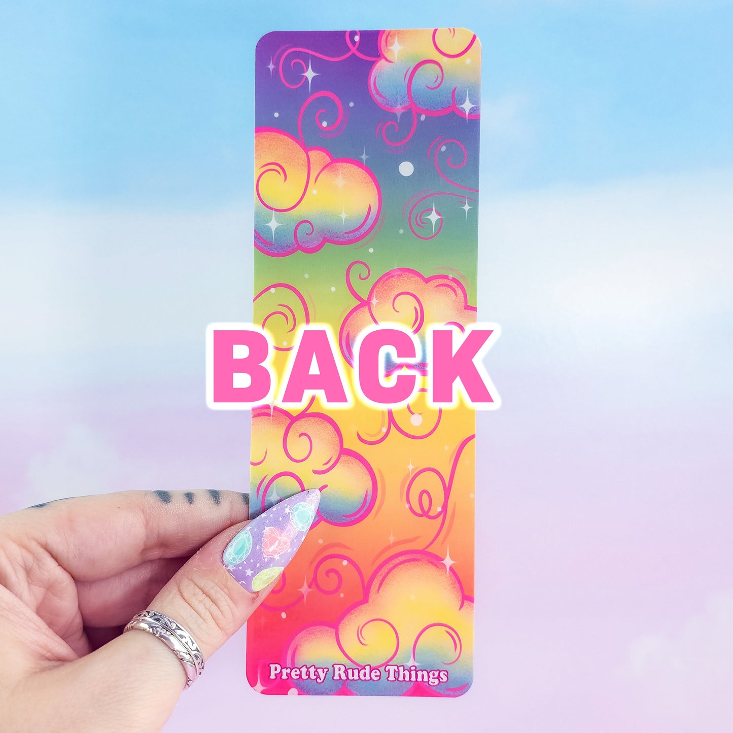 Back of rainbow holographic clouds bookmark – colorful laminated design, handmade by Pretty Rude Things