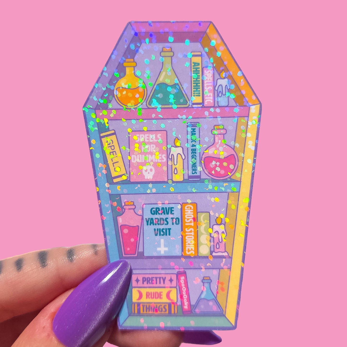 Coffin shaped bookcase sticker with potion bottles and books on a pink background