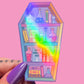 Coffin shaped bookcase sticker with potion bottles and books on a pink background