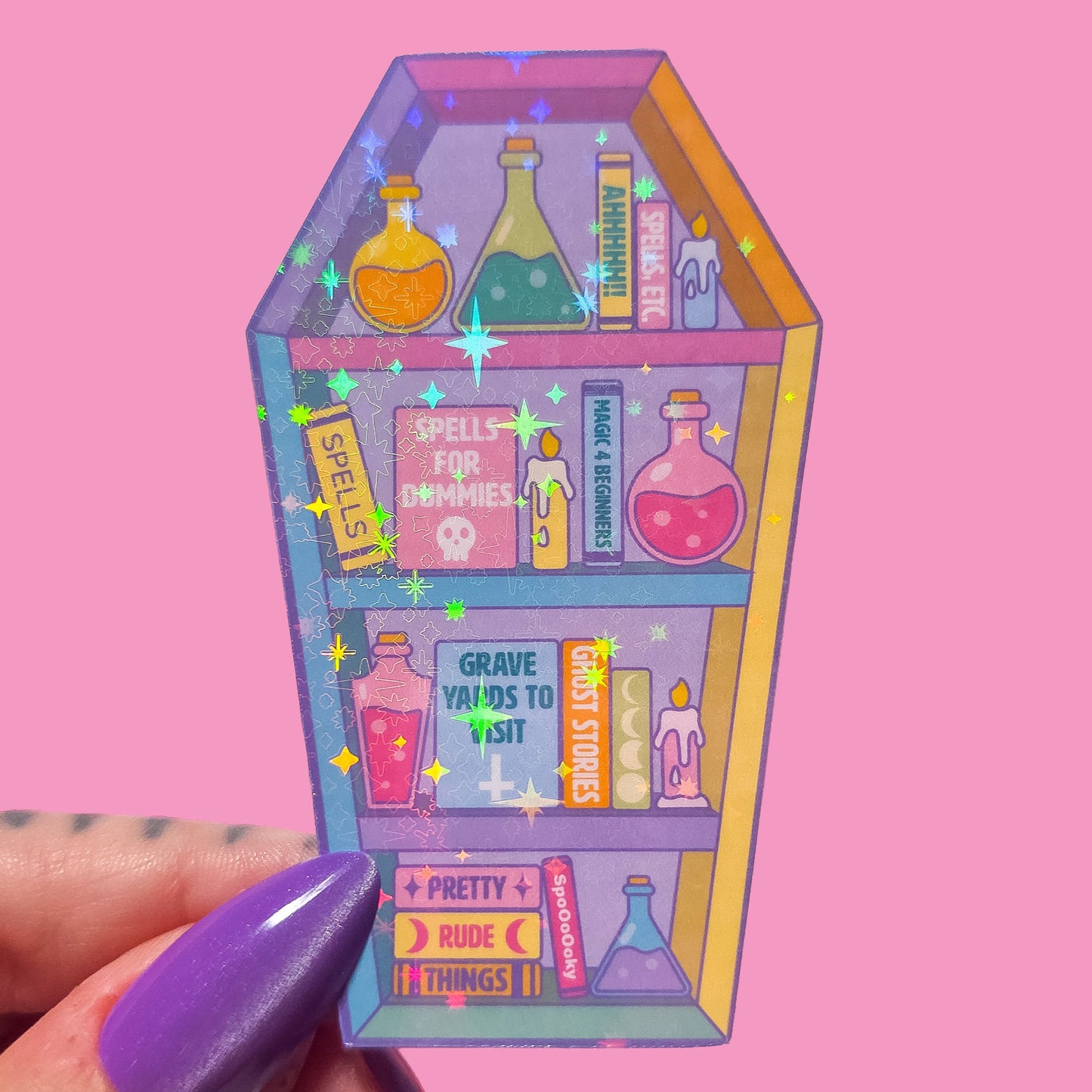 Coffin shaped bookcase sticker with potion bottles and books on a pink background