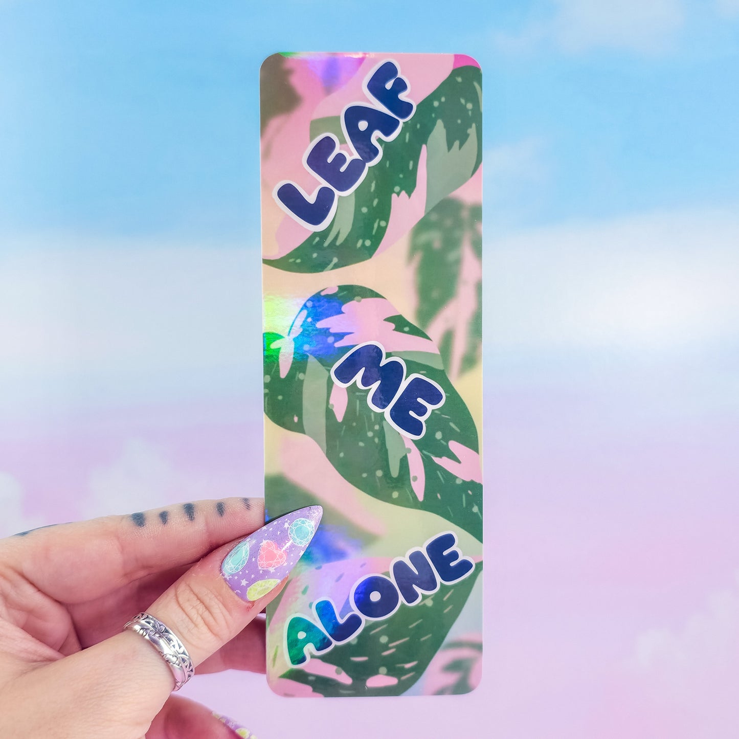 Leaf Me Alone holographic bookmark – glossy laminated pink princess philodendron leaf design, handmade punny book accessory