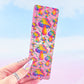 Back of rainbow mushroom holographic bookmark with Pretty Rude Things watermark, held in hand