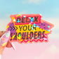 Colorful card with 'Relax Your Shoulders' text held by a hand against a blurred background