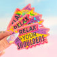 Colorful 'Relax Your Shoulders' stickers held by a hand with a blurred background