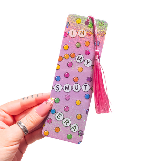 In My Smut Era friendship bracelet holographic bookmark with tassel on a white background